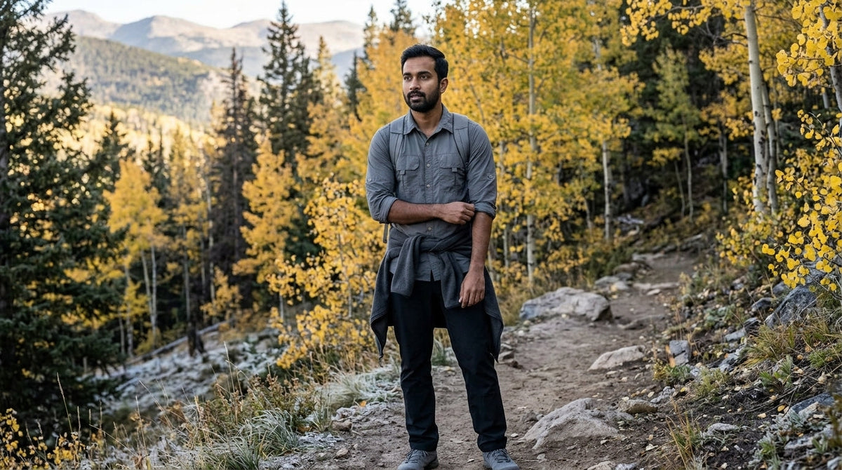 Man in a grey long-sleeve quick-dry shirt rolling a sleeve on a frosty October switchback in the Colorado Front Range