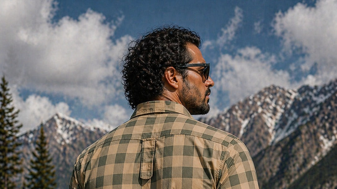 Man in a khaki and green plaid flannel shirt, a classic fall shirt for apple picking and orchard trips