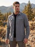 Man wearing FREDD MARSHALL high-performance outdoor shirt in a rugged mountain setting