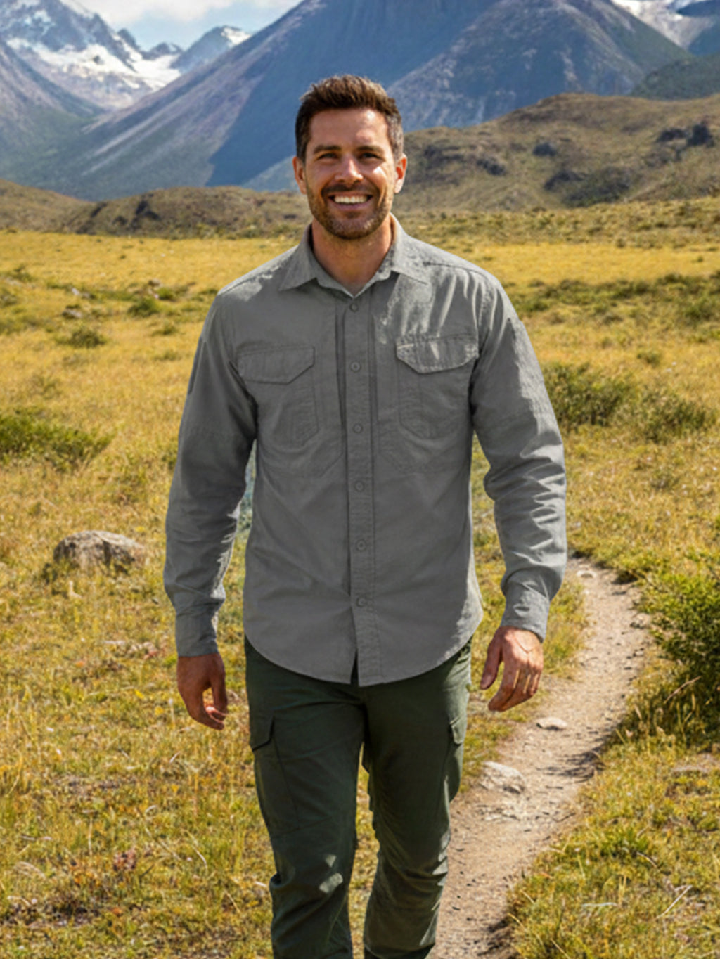 Man wearing high-performance outdoor apparel hiking in mountains, FREDD MARSHALL style