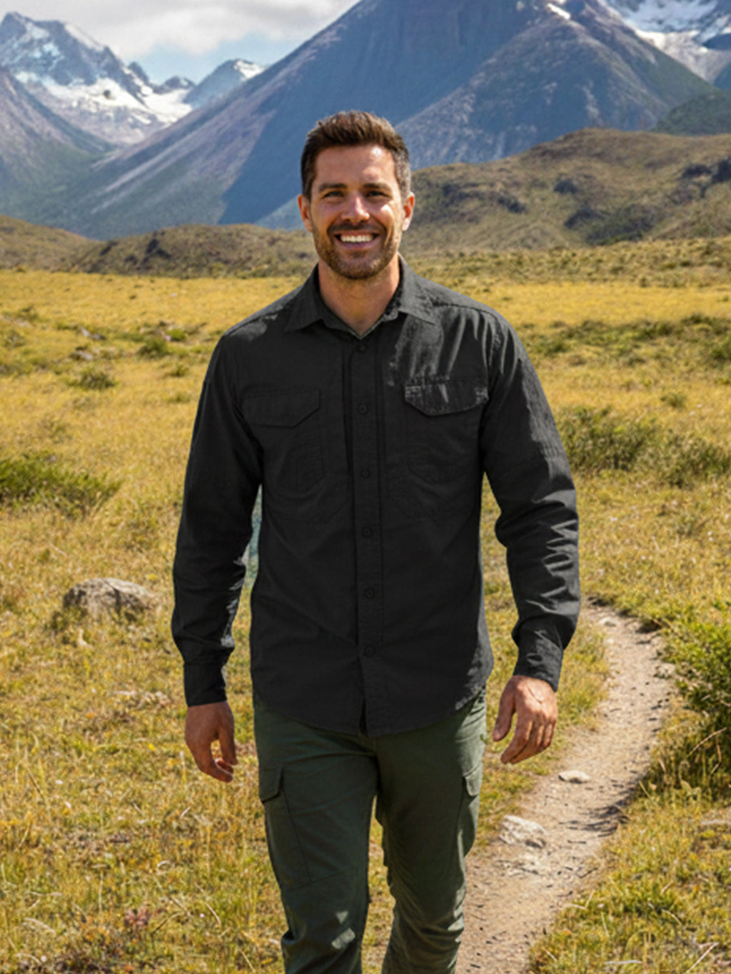 Man in high-performance outdoor apparel hiking in mountain landscape, FREDD MARSHALL