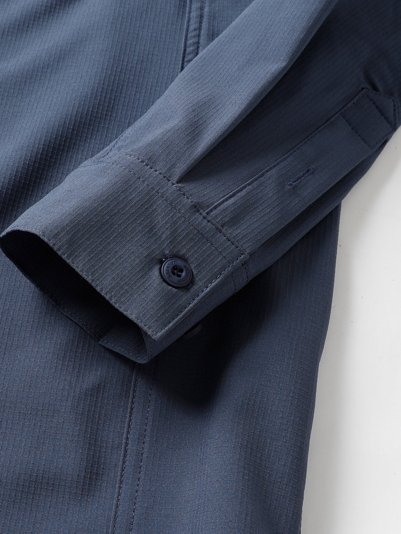 Fredd Marshall high-performance outdoor jacket sleeve in dark blue technical fabric