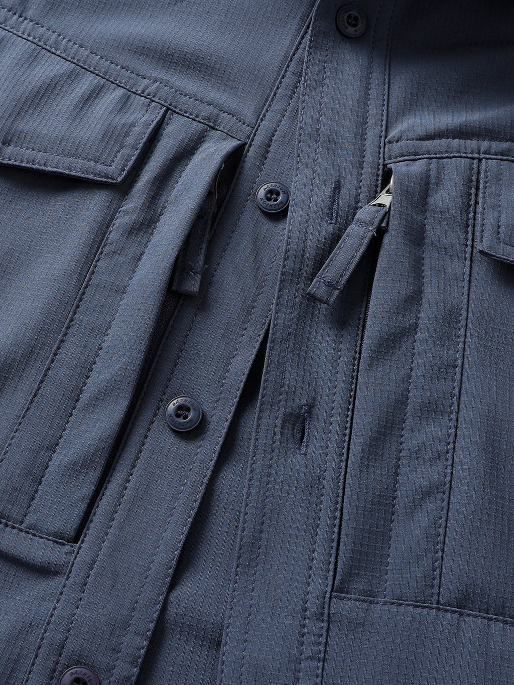 Close-up of a high-performance FREDD MARSHALL outdoor jacket, featuring pockets and zippers.