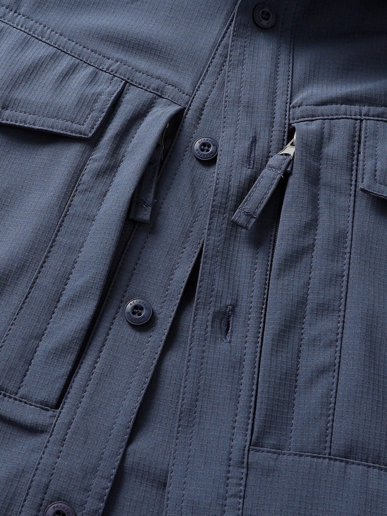 Close-up of a high-performance FREDD MARSHALL outdoor jacket, featuring pockets and zippers.