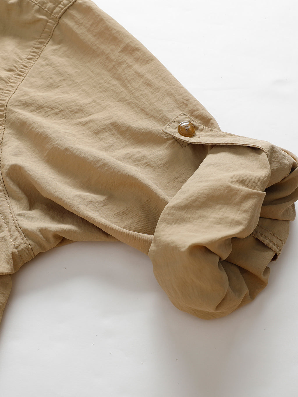 Beige rolled-up sleeve detail on high-performance outdoor apparel by FREDD MARSHALL