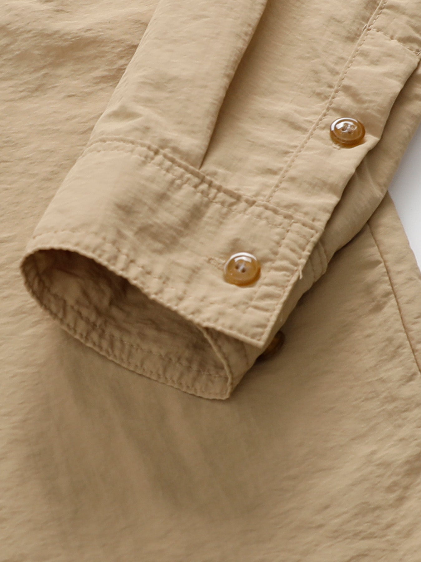 Beige cuff detail on high-performance outdoor apparel by FREDD MARSHALL