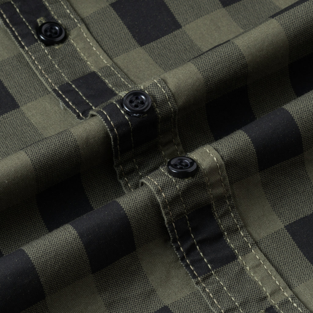 Close-up of high-performance outdoor plaid shirt with black buttons by FREDD MARSHALL