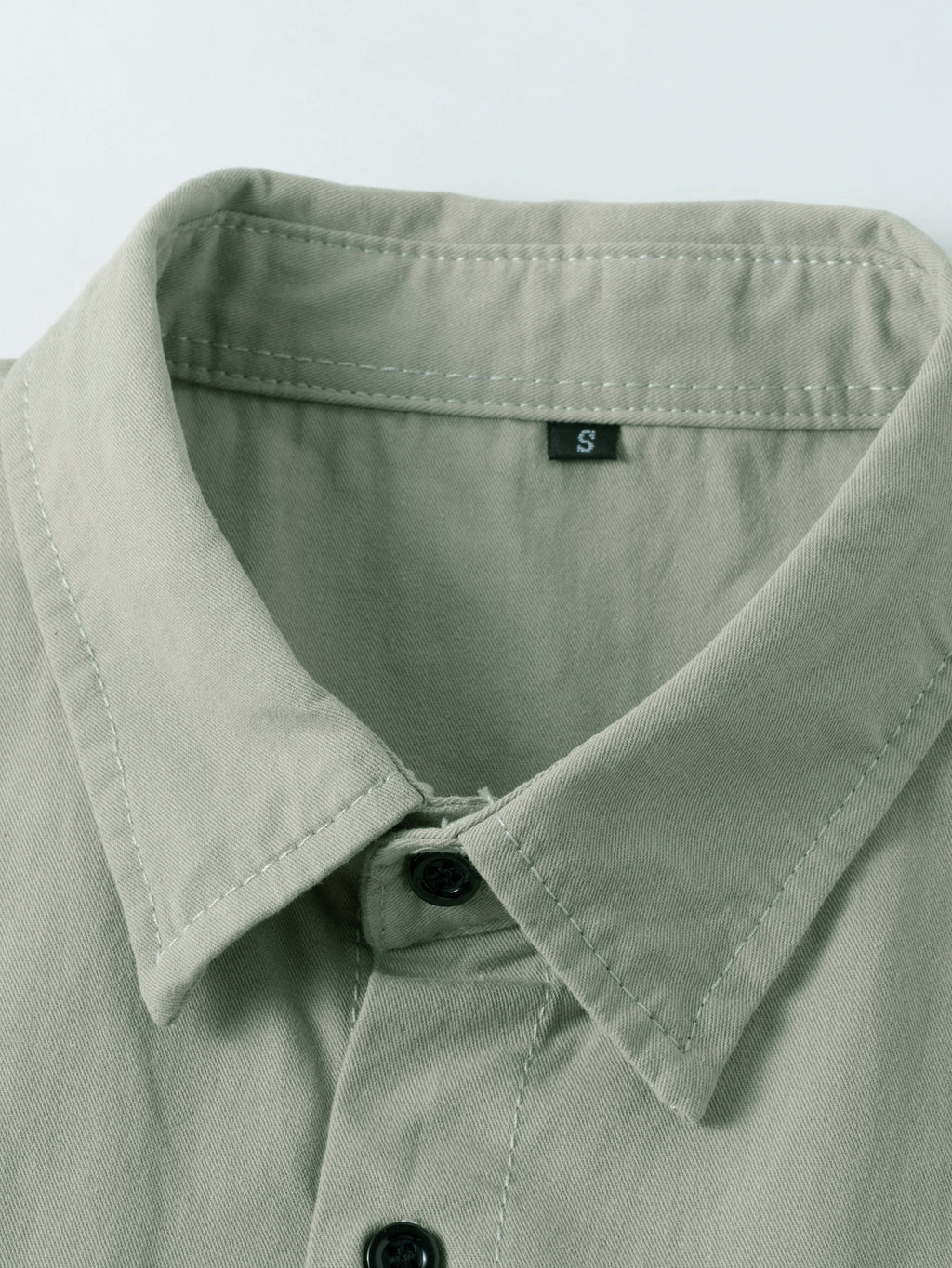 High-performance outdoor apparel by FREDD MARSHALL, close-up of khaki shirt collar