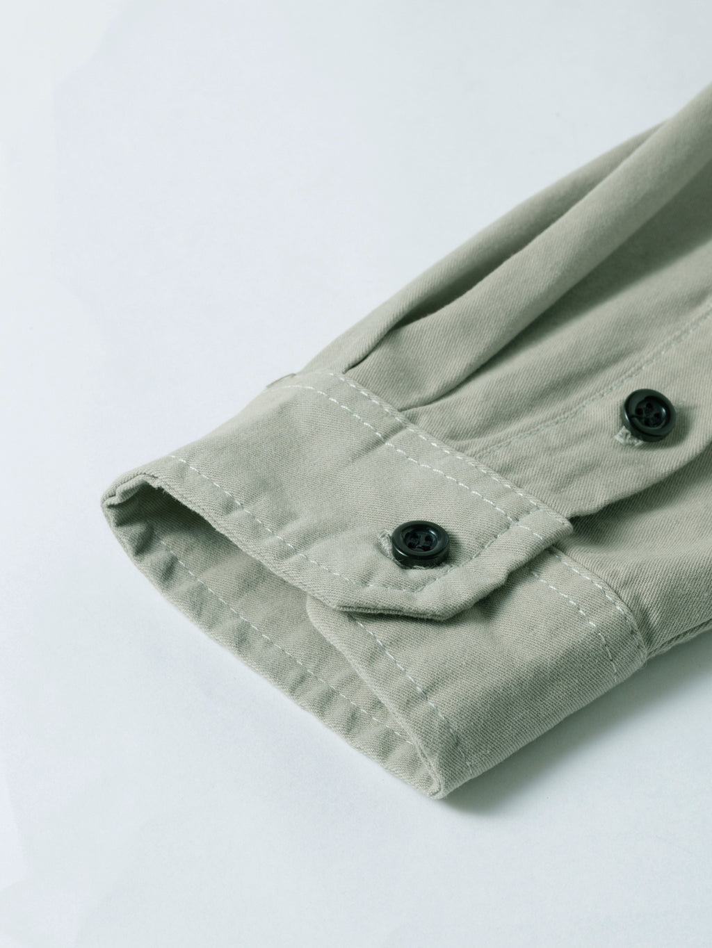 High-performance outdoor apparel, close-up of khaki shirt sleeve with button, Fredd Marshall